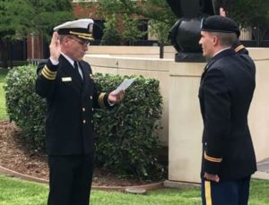 Brian Foy swears in his youngest son Connor as an Army 2nd Lieutenant